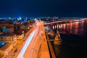 Highway at night in modern city. Aerial view of cityscape photo