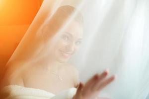 Beautiful bride posing in daylight photo