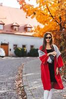 Fashion portrait of beautiful woman in autumn park photo