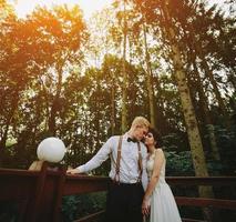 bride and groom posing on the verandah photo