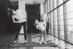 Two girls of different ages makeing yoga photo