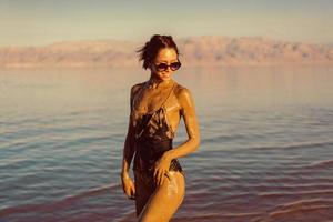 A young woman enjoying the natural mineral mud photo