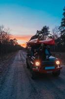 Woman sitting on front on a hood 4x4 terrain vehicle. photo