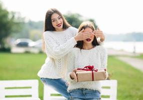 Two beautiful girls and gift photo