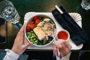 Healthy breakfast bowl with porridge and fresh vegetable salad photo