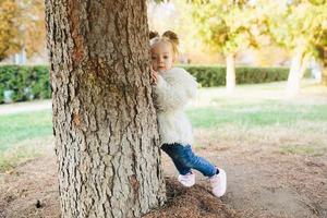 Cute little girl is playing outdoors photo