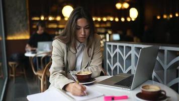 Woman working sitting in coffee shop video