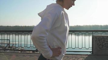 Woman exercises on concrete surface in the city on a sunny day video