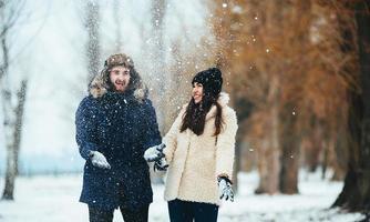 boy and girl playing with snow photo