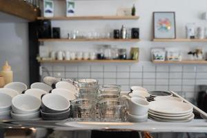 A kitchen countertop and a sink with dishes. photo