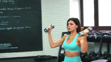 Fitness woman in active wear working out at gym video