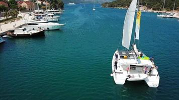 Sailing yacht sails on sparkling water on bright sunny day video