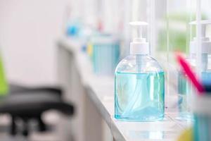 Blue alcohol gel bottle placed on the table to serve customers within a bank, measures to prevent the spread of respiratory viral disease photo