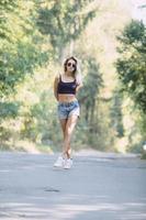 beautiful girl walking down a forest road photo