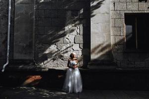 bride posing on stone wall background photo