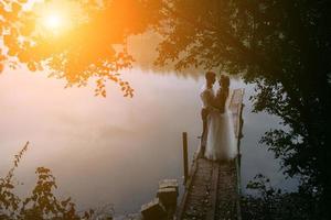 Wedding couple on the old wooden pier photo