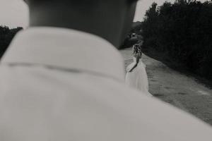 bride leads groom on the road photo