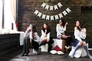 Four charming model posing on a vintage New Year's background photo