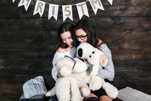 dos niñas encantadoras jugando con juguetes de navidad foto