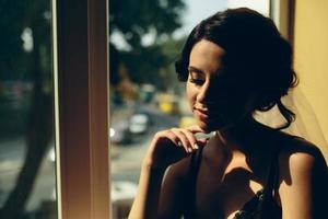 bride looking through the window photo