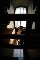 bride and groom on the background of a window. photo