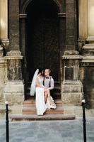 Bride sitting on lap of the bride photo