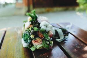 Wedding bouquet on a bench photo