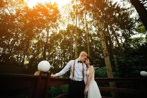 bride and groom posing on the verandah photo