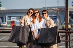 Young women with shopping bags on a bus stop photo