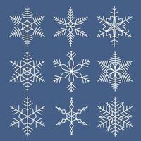 White snowflakes set isolated on blue background. Snow elements for Christmas holidays. Icy objects for greeting card decoration. Cool design vector illustration.