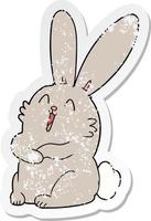 distressed sticker of a cartoon laughing bunny rabbit vector