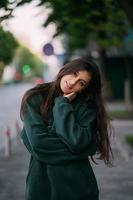 Portrait of cute girl with long hair looks at the camera photo