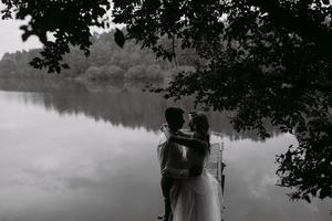 Wedding couple on the old wooden pier photo