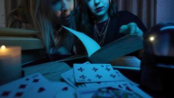 Two women are reading a mysterious book photo