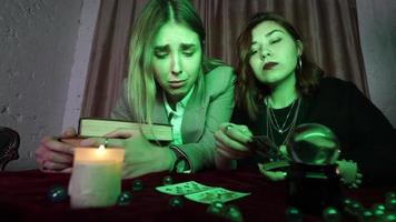 Fortune teller forecasting the future to woman with cards photo