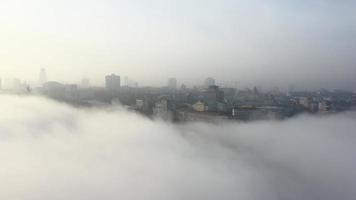 Aerial view of the city in the fog. photo