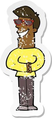 retro distressed sticker of a cartoon grinning man wearing sunglasses