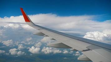 Wing of airplane on sky and cloud on moving, view from airplane cabine video