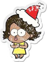 distressed sticker cartoon of a girl pouting wearing santa hat vector