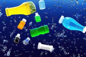 Botellas de plástico problemáticas y microplásticos flotando en el océano. foto