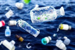 Problem plastic bottles and microplastics floating in the ocean. photo