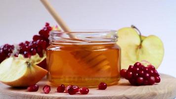 Happy Rosh Hashanah. Jewish holiday New Year. Honey, apples and pomegranates on white background. video