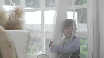 Portrait of Young Asian Child Playing Hide and Seek in Living Room video