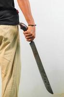 Man holding machete isolated photo