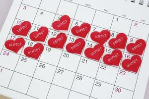 Text on red heart shape on calendar. IVF embryo transfer day 5. photo