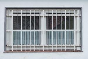 barred window on a house photo