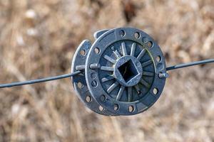 cast iron tension wheel of a fence photo