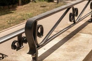 stairs with cast iron railing outside photo