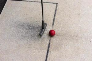 Miniature golf club with red ball photo