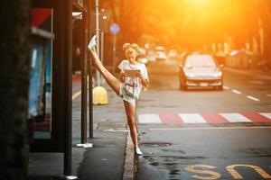 Cute girls with tablet on a bus station with a leg split photo